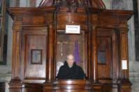 An English speaking priest at St Peter's Basilica waiting to hear confessions